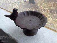 Old small cast iron candle holder with a chick
