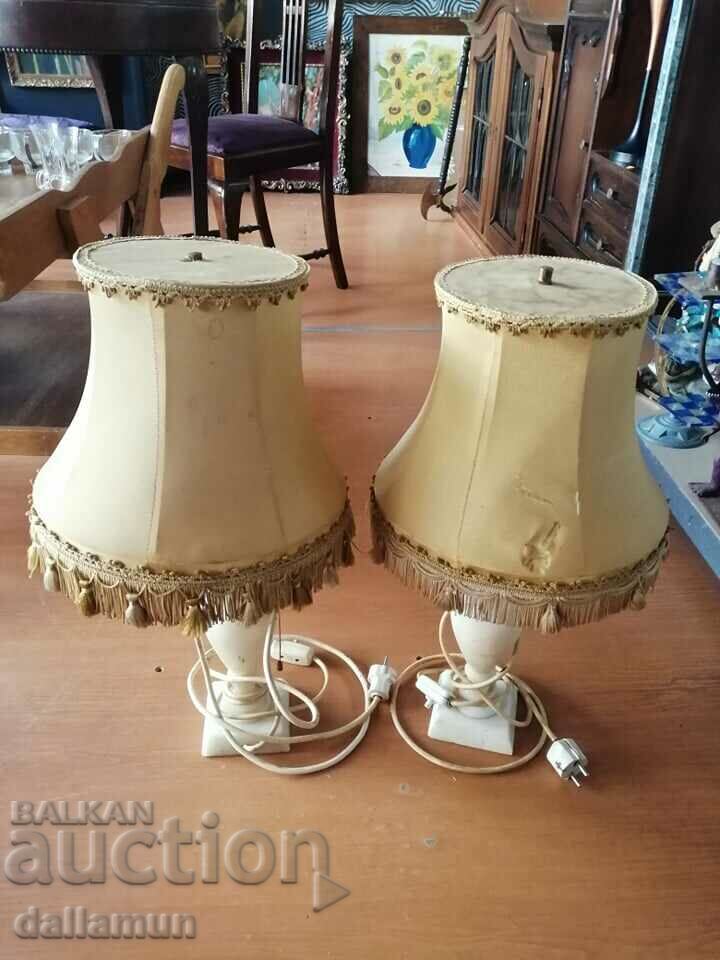 a pair of lamps with marble bases