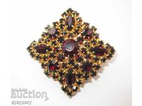 A beautiful old lady's gold-plated brooch with garnet stones