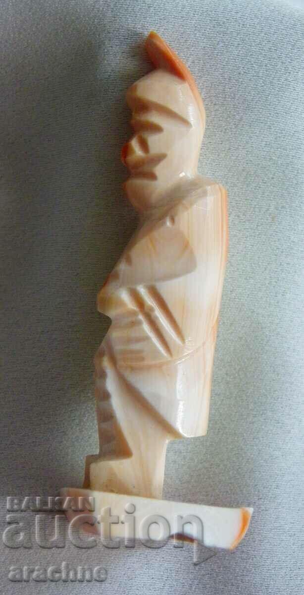 Auction Aztec priest figure from a red snail shell Auction Aztec priest figure from a red snail shell