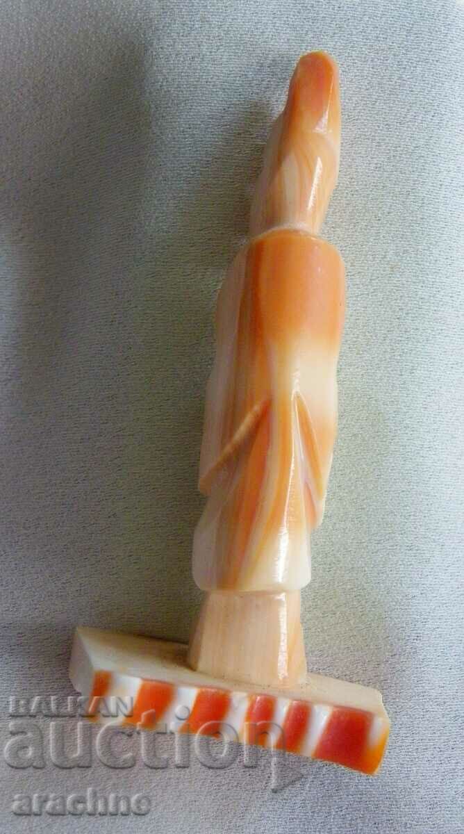 Delivery of Aztec priest figure from a red snail shell Delivery of Aztec priest figure from a red snail shell