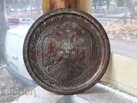 A large copper tray with a double-headed eagle