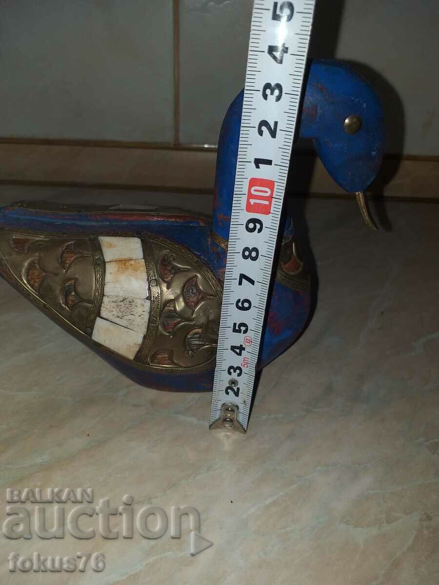 Delivery of A great blue wood duck with brass and bone Delivery of A great blue wood duck with brass and bone