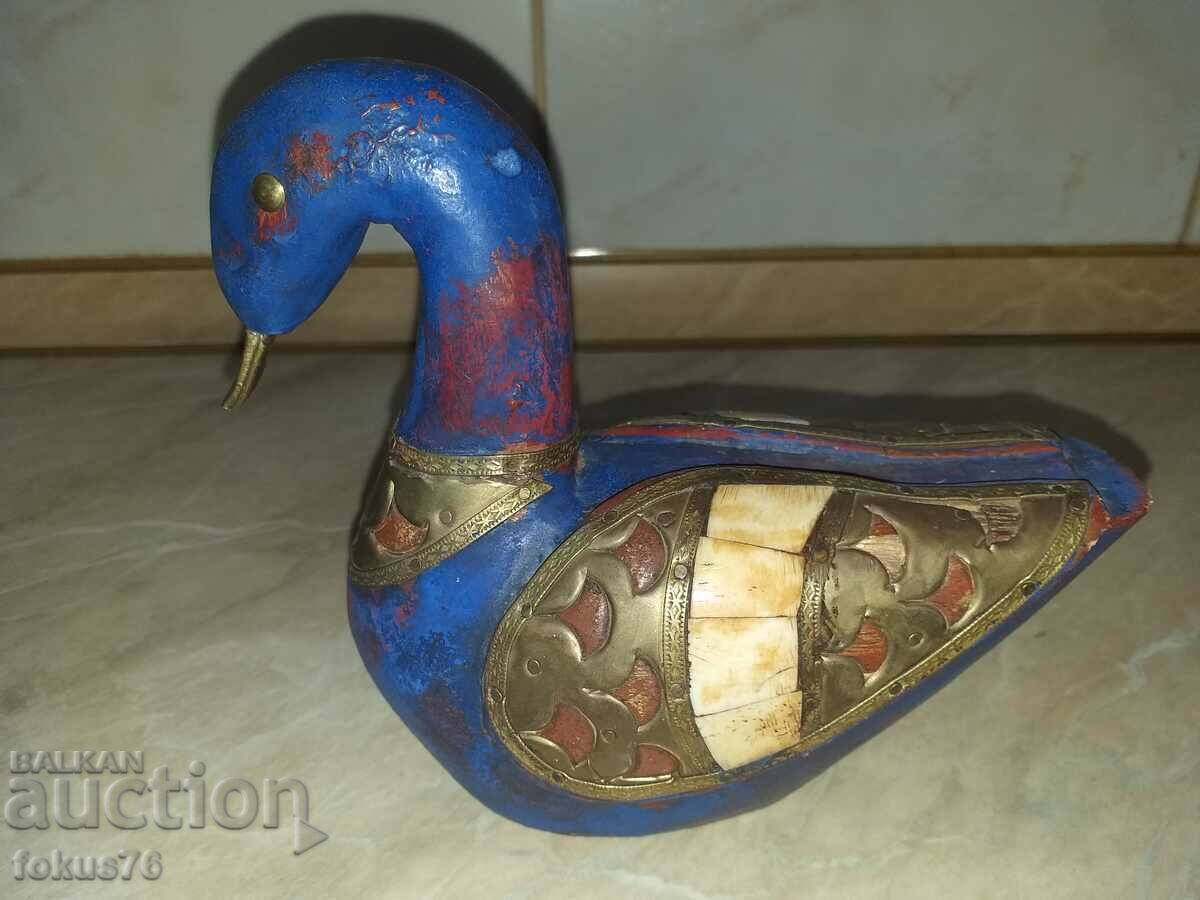 A great blue wood duck with brass and bone