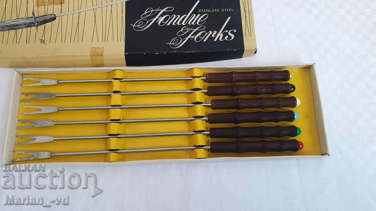 Auction Set of fondue forks with wooden handles Auction Set of fondue forks with wooden handles