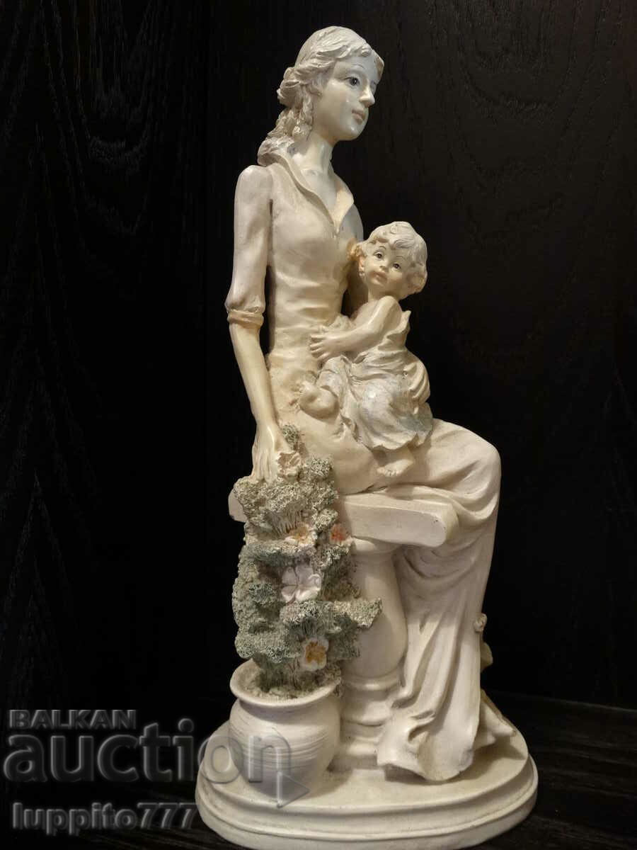 Auction Sculpture statuette of a female figure with a child Auction Sculpture statuette of a female figure with a child