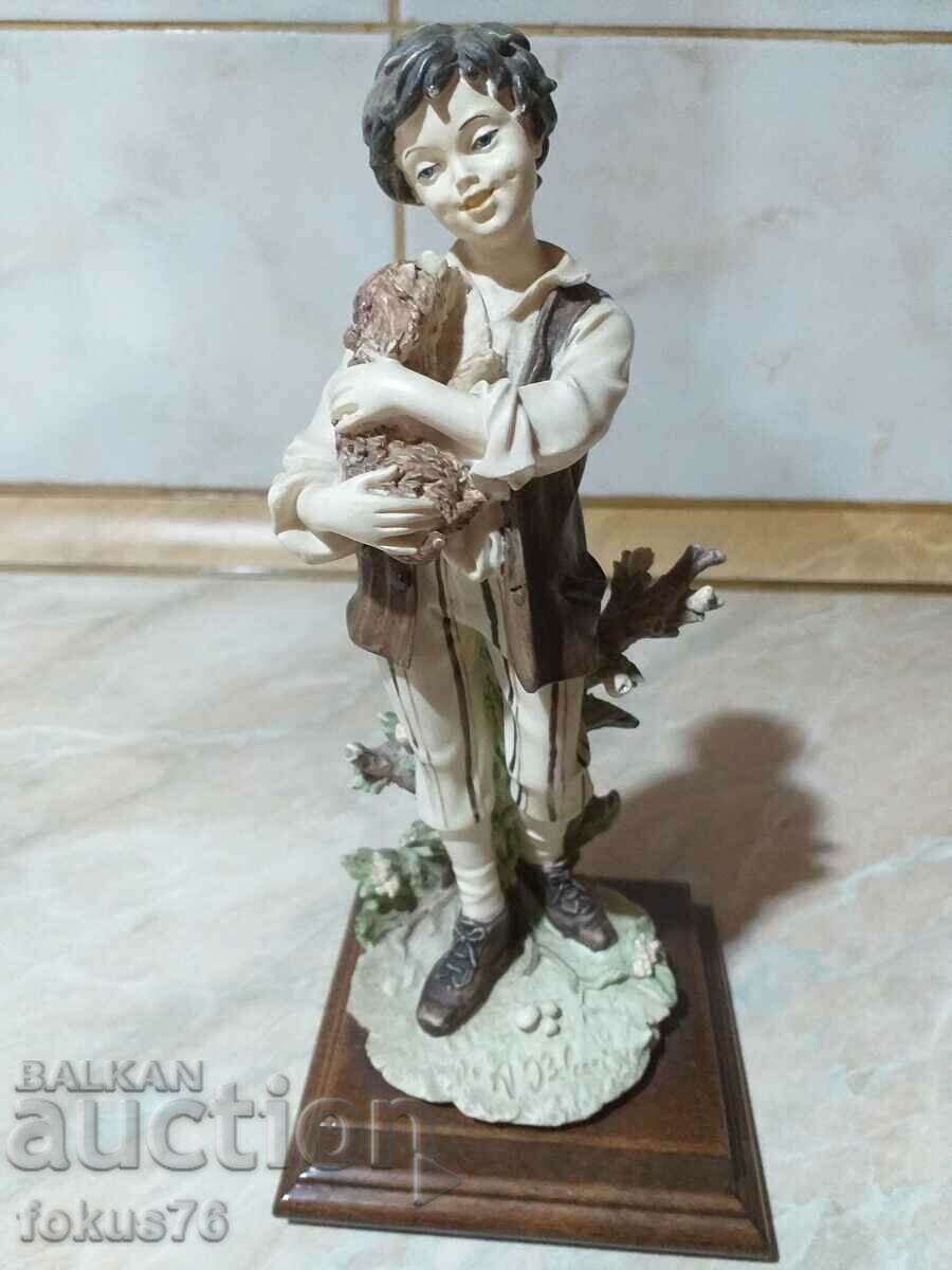 A great beautiful figurine of a boy with a dog signed