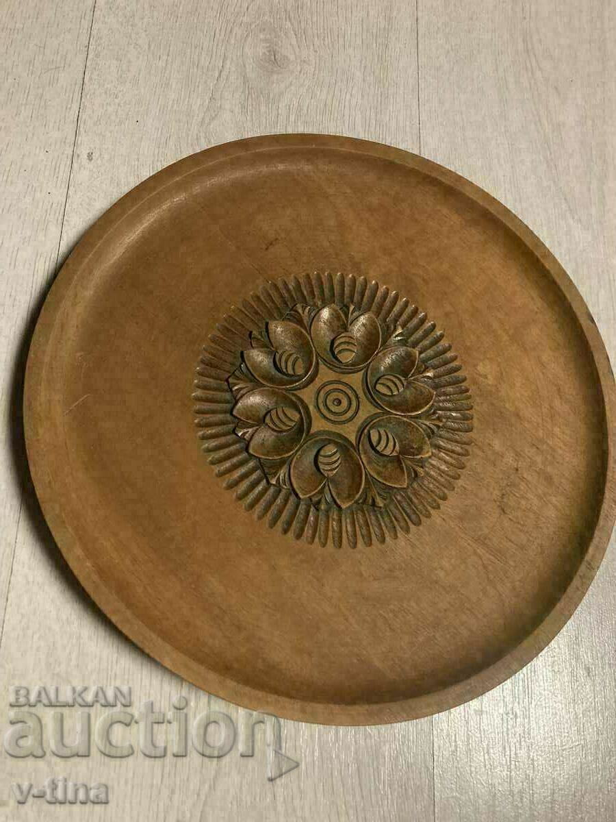 Large beautiful wooden plate with carvings