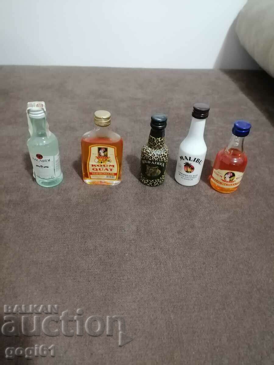 Branded alcohol advertising bottles, old.