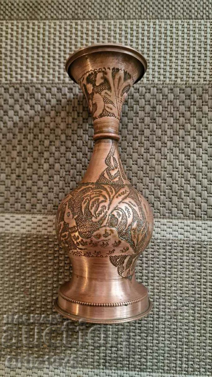Wrought copper vase with animals.