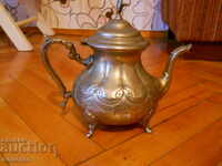 antique kettle with an eagle on the lid