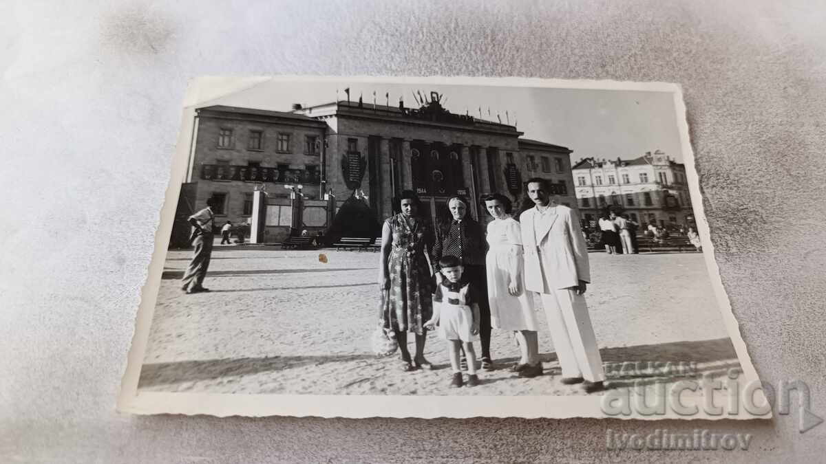 Photo Man, three women and a boy in the square 1957
