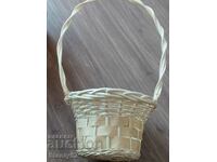 A beautiful white woven wooden basket. For a wedding bouquet.