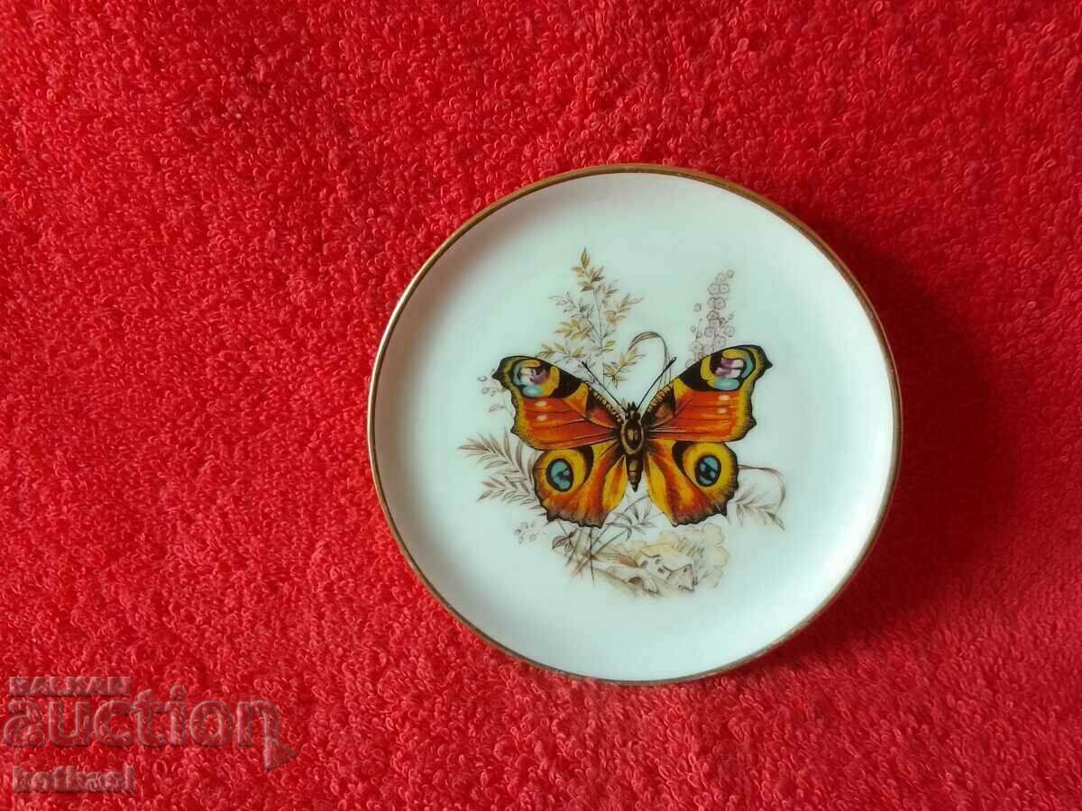 Delivery of Old small porcelain plate Peacock butterfly marked Delivery of Old small porcelain plate Peacock butterfly marked