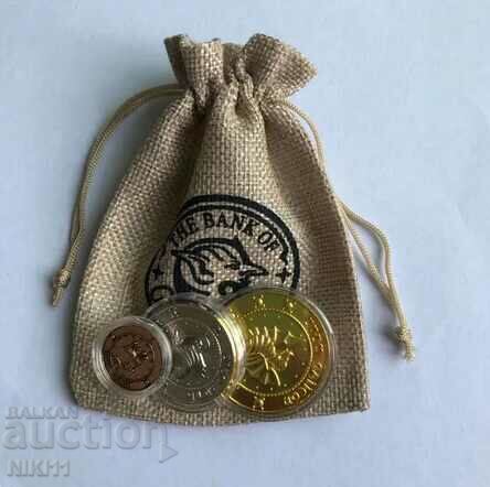 3 Harry Potter coins in protective capsules in a coin bag