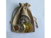 3 Harry Potter coins in protective capsules in a coin bag