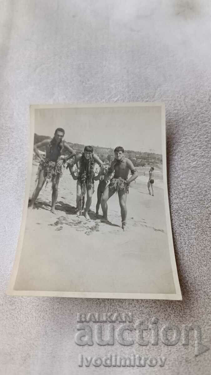 Photo Three young men on the beach in front of MEI Balkantourist 1957