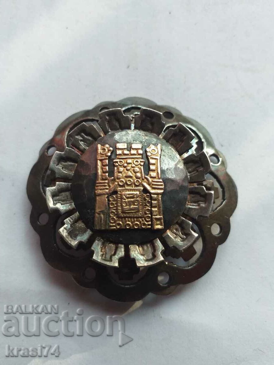 Silver brooch with gold elements