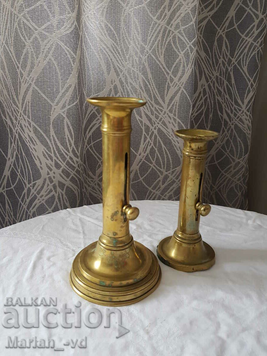 Auction Two bronze candlesticks with lifter Auction Two bronze candlesticks with lifter