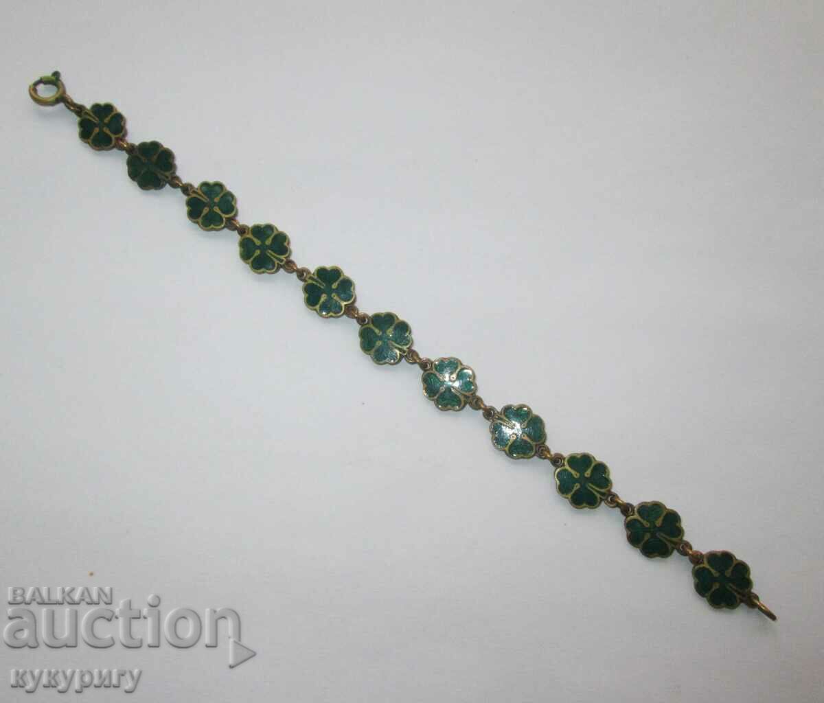 Old green enamel bracelet with four-leaf clovers for luck
