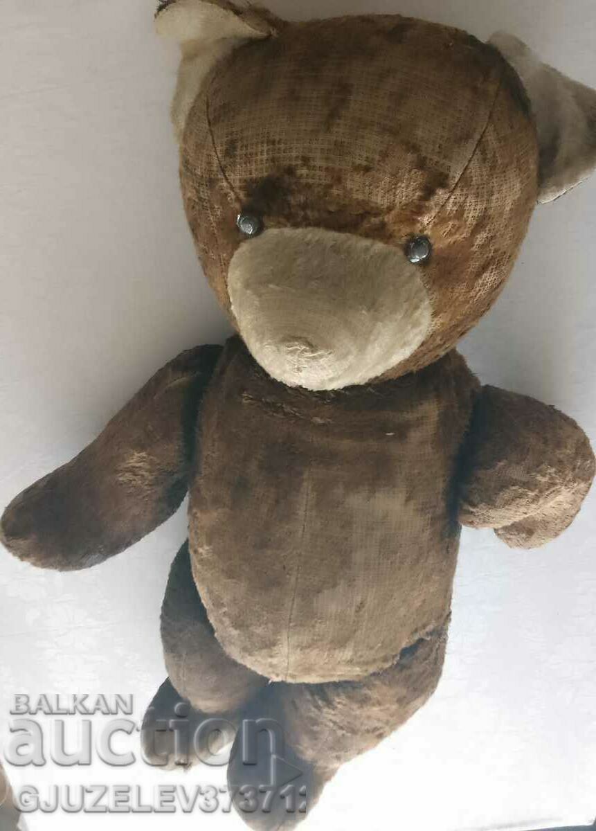 Old teddy bear stuffed with straw