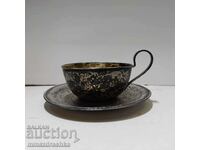 ceașcă de ceai și farfurie din argint