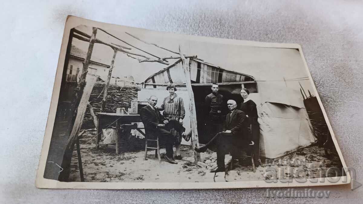 Photo Two men, a woman, a boy and a girl in front of a tent