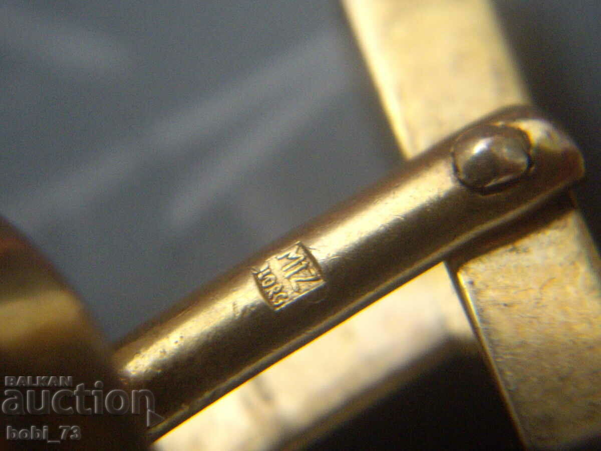 Auction  An old cufflink.