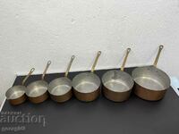 Set of copper pans with bronze handles. #5122