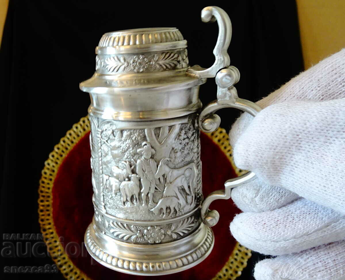 Auction Pewter mug with three village paintings. Auction Pewter mug with three village paintings.