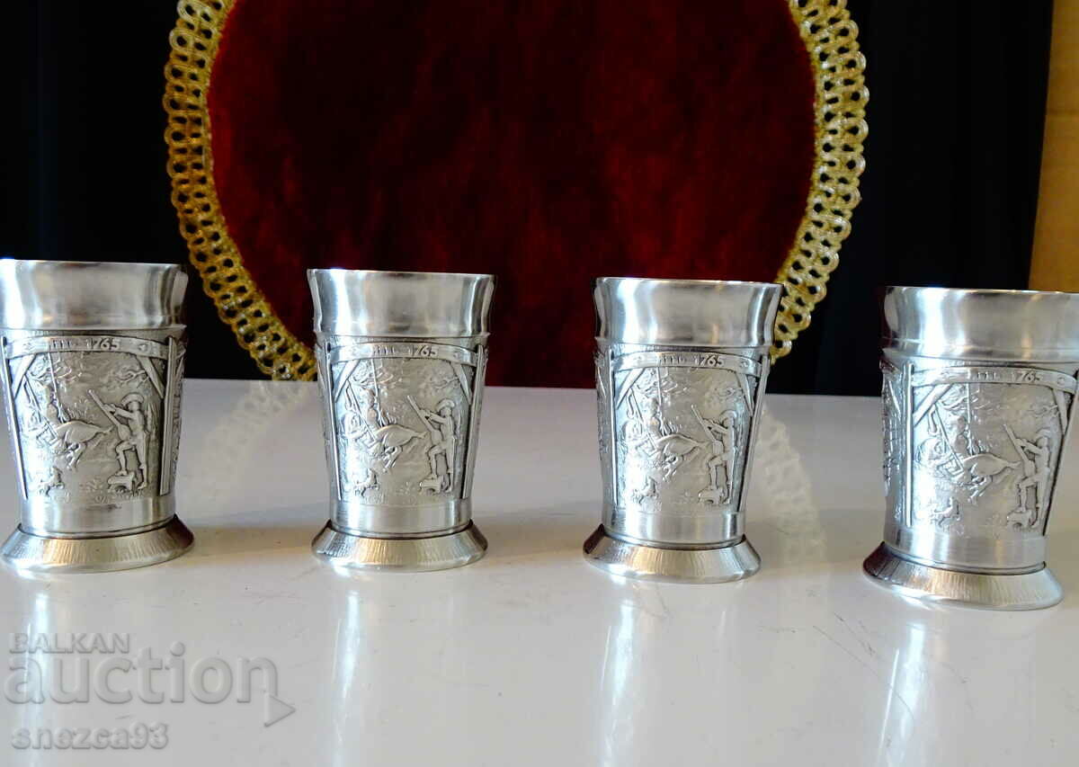Pewter brandy glasses with three romantic paintings.