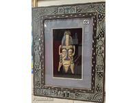 Wooden mask in a frame