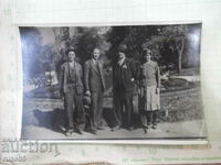 Old photo of three men and a woman in the park
