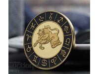 Taurus zodiac coin in a protective capsule, zodiac signs, zodiac