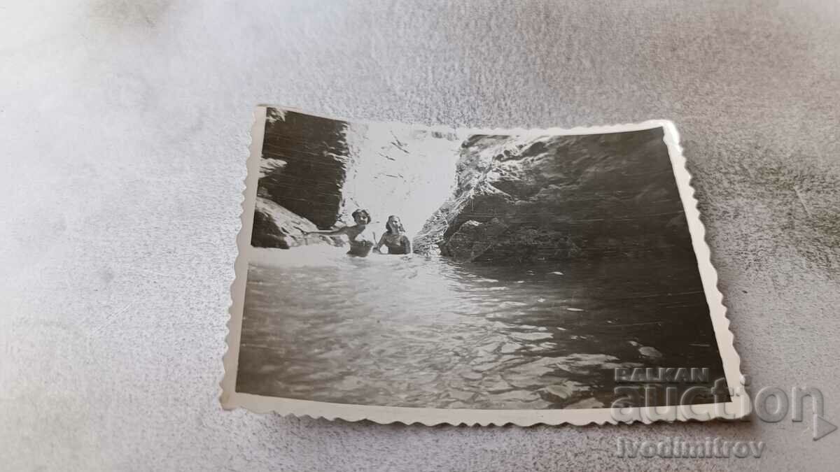 Photo Two women in the pool of a waterfall