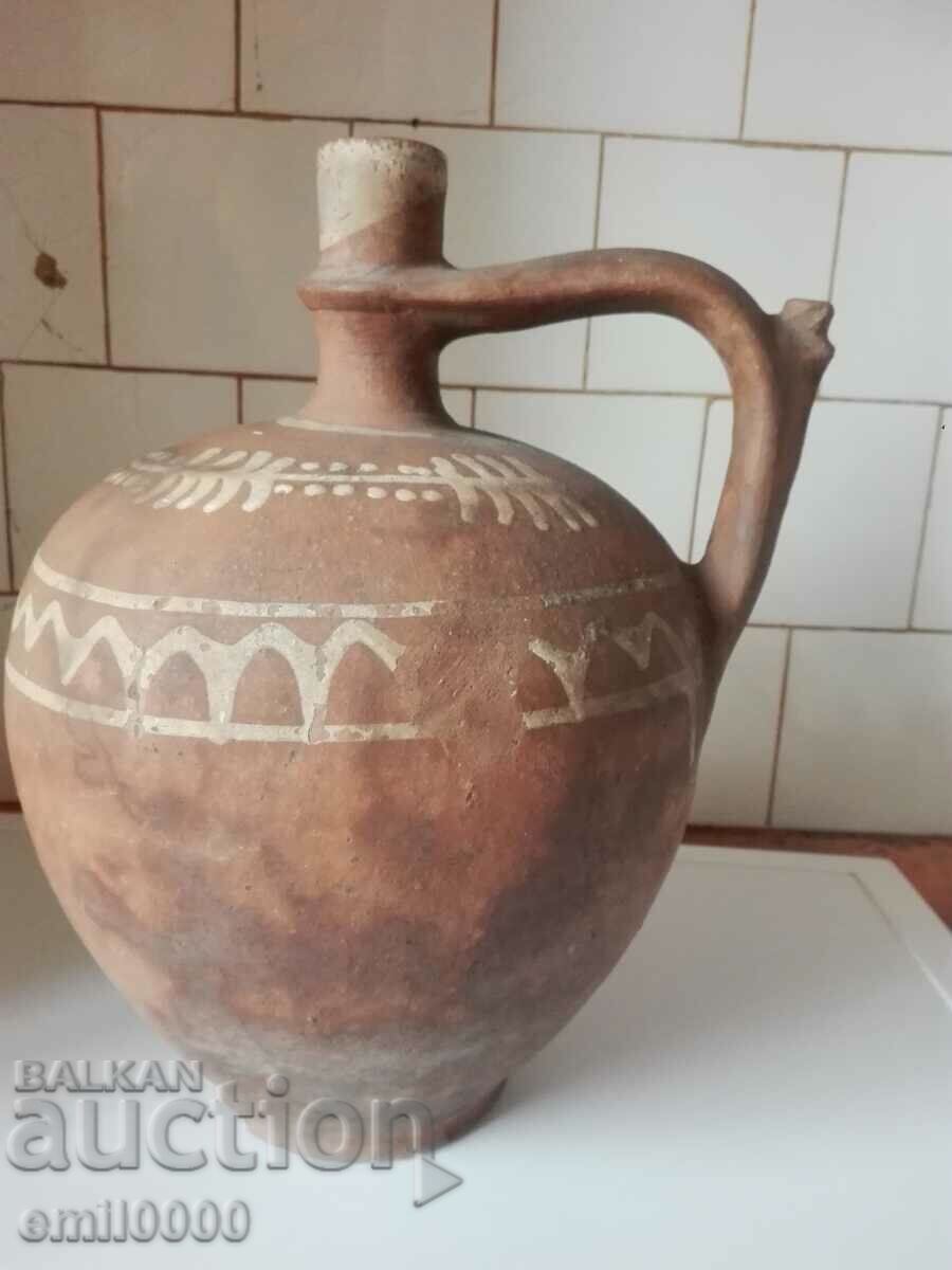 A large clay pitcher.