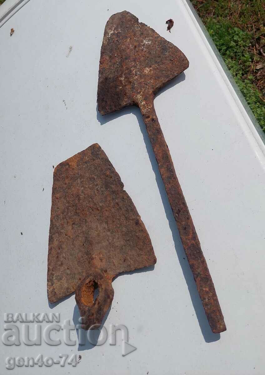 an old forged ploughshare and a forged hoe