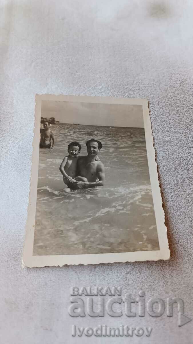 Picture A man and a little boy in the sea