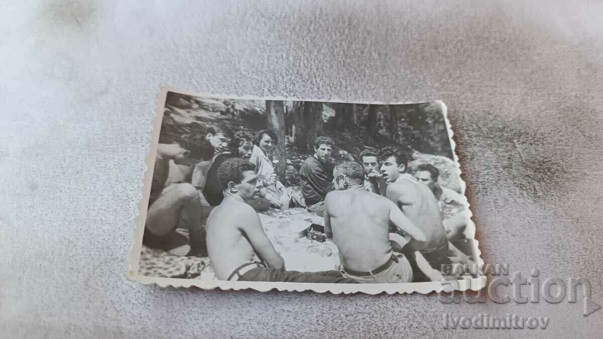 Picture Young men naked to the waist on a picnic