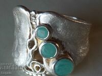 Silver ring with emeralds.