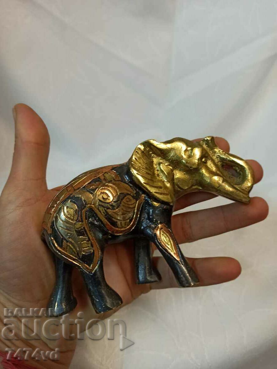 Bronze sculpture of an elephant with flower ornaments