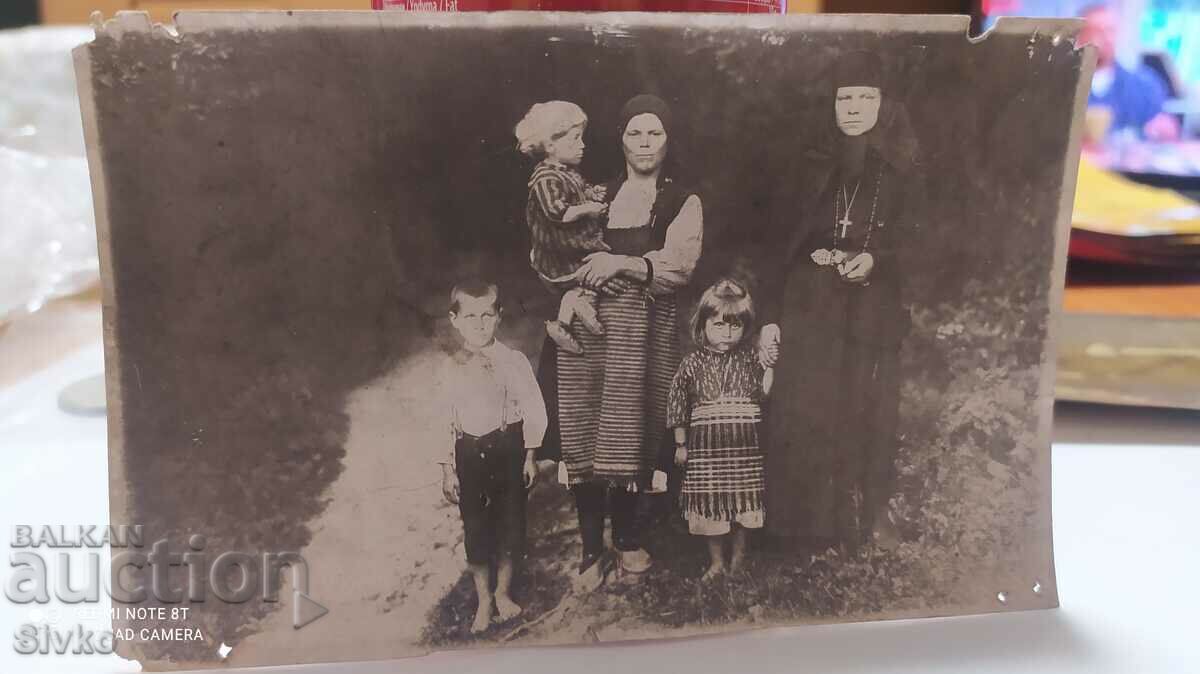 Photo, mother with her children and with a nun