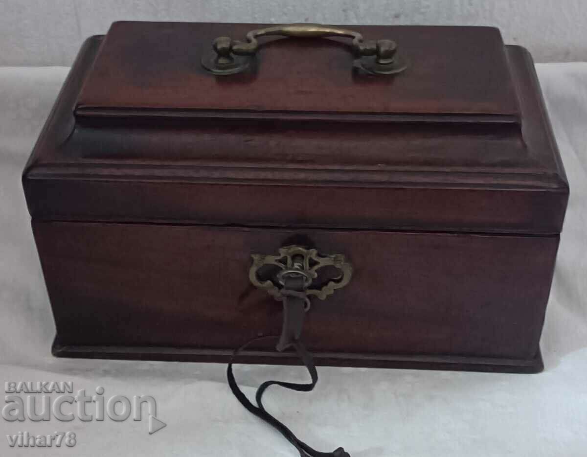 Old wooden box with a key for jewelry