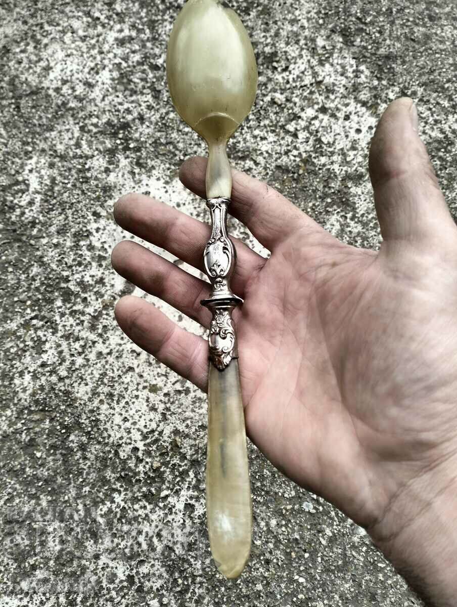 Delivery of Old spoon made of horn and metal Delivery of Old spoon made of horn and metal