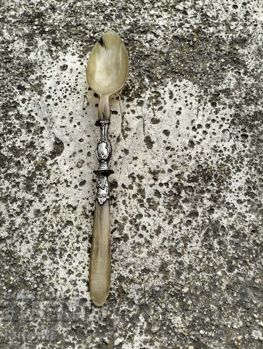 Old spoon made of horn and metal