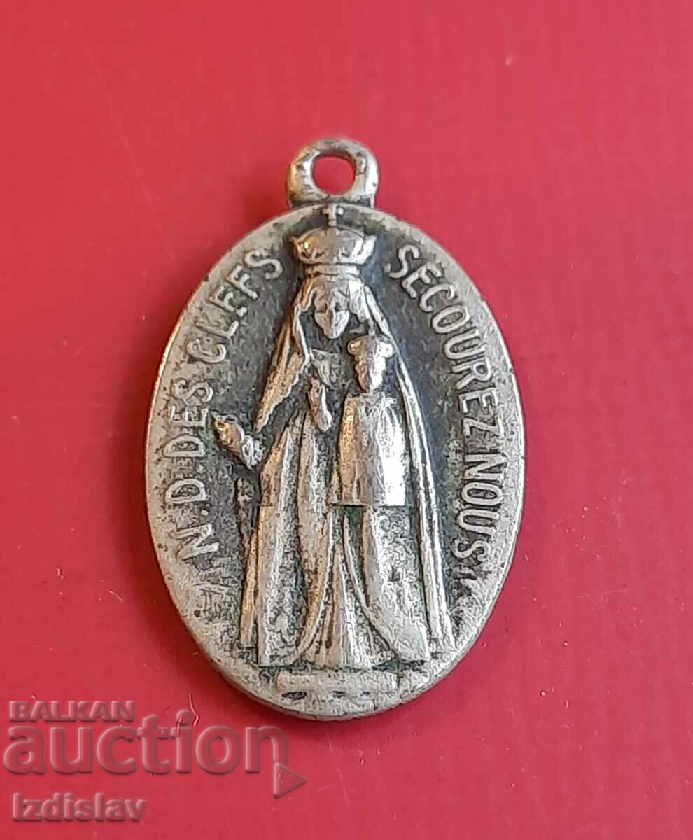 Ένα μικρό μετάλλιο διπλής όψης με την Παναγία και τον Ιησού.