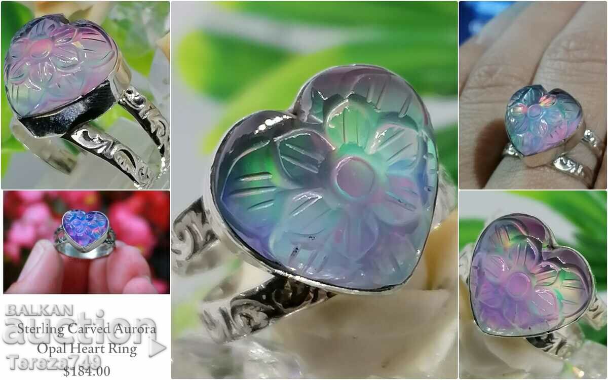 Silver ring with beautiful ornaments and carved opal