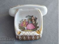 An old porcelain ashtray in the shape of a telephone