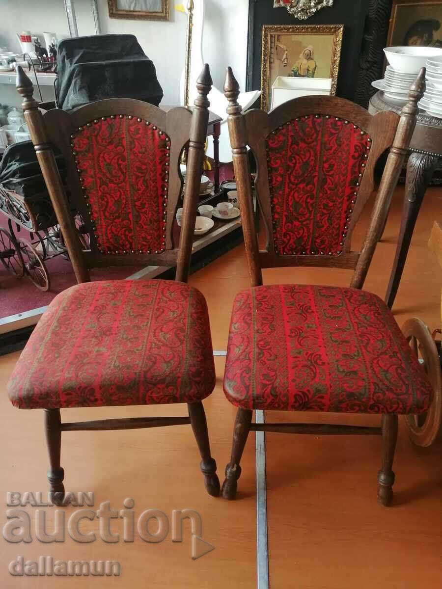 a pair of old wooden chairs