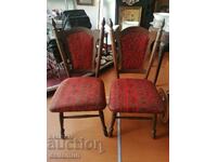 a pair of old wooden chairs